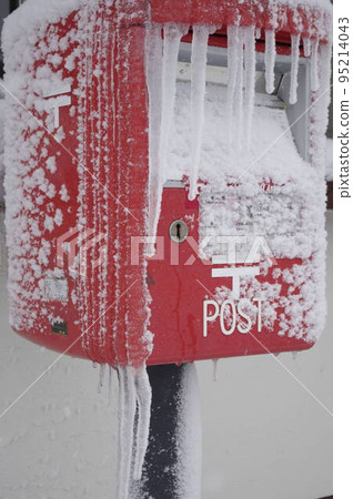 Icicles and red mailbox 2 on a snowy hat 95214043