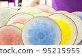 Bright multicolored colorful plates. New empty pottery 95215955