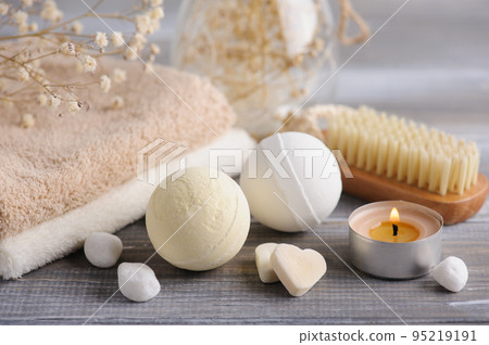 Bath bombs with dry flowers and lit candles Bath bombs with dry flowers and lit candles 95219191