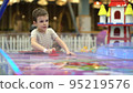 Joyful playful boy playing air hockey on the playground. Entertainment for children 95219576