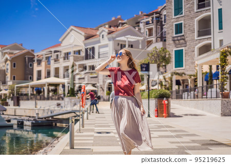 Woman tourist enjoying the views of Architecture and luxury yachts in Lustica Bay, Montenegro. Travel around Montenegro concept. Go Everywhere Woman tourist enjoying the views of Architecture and luxury yachts in Lustica Bay, Montenegro. Travel around Montenegro concept. Go Everywhere 95219625
