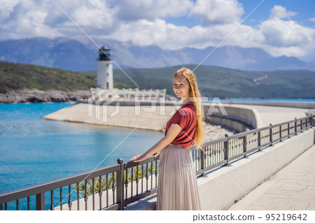 Woman tourist enjoying the views of Architecture and luxury yachts in Lustica Bay, Montenegro. Travel around Montenegro concept. Go Everywhere Woman tourist enjoying the views of Architecture and luxury yachts in Lustica Bay, Montenegro. Travel around Montenegro concept. Go Everywhere 95219642