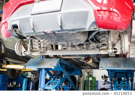 car on lifts in auto service centre for maintenance and tire replacement car on lifts in auto service centre for maintenance and tire replacement 95219853