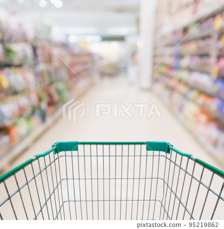 Empty shopping cart with abstract blur supermarket discount store aisle and product shelves interior defocused background Empty shopping cart with abstract blur supermarket discount store aisle and product shelves interior defocused background 95219862