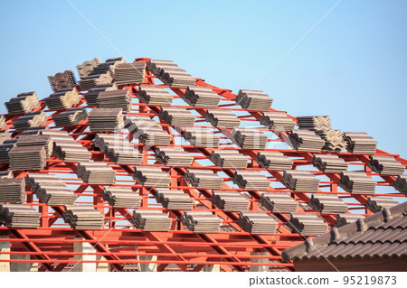 Roof house construction with lots of tile prepare to Install Roof house construction with lots of tile prepare to Install 95219873