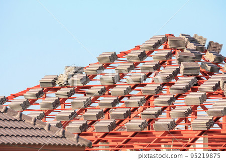 Roof house construction with lots of tile prepare to Install Roof house construction with lots of tile prepare to Install 95219875
