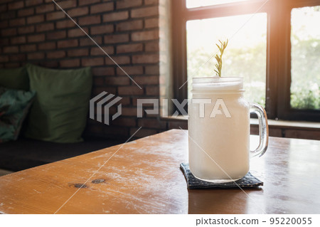 coconut water frappe with rosemary leaf on restaurant table 95220055