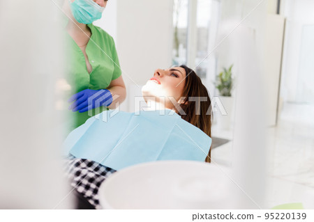 Dentist doing dental checkup for his patient. Dentist doing dental checkup for his patient. 95220139