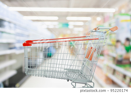 Supermarket aisle with empty shopping cart at grocery store retail business concept 95220174