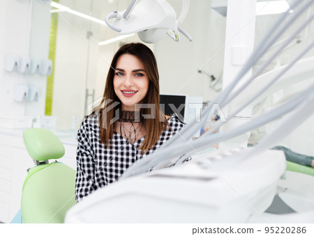 Portrait of a young beautiful woman in the dental office. Portrait of a young beautiful woman in the dental office. 95220286