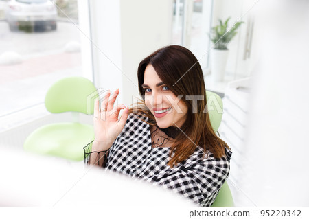 Satisfied dentistry patient shows okay gesture. Satisfied dentistry patient shows okay gesture. 95220342