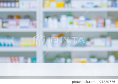 Empty white counter with pharmacy drugstore shelves blurred background 95220776