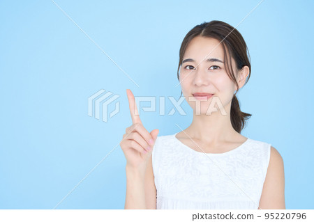 A young woman posing with her index finger up 95220796