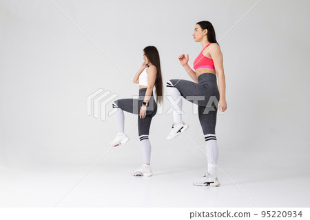 Two young fitness women exercising in the studio 95220934