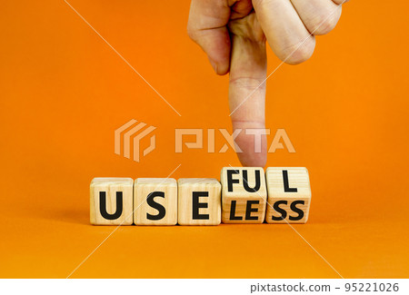 Useful or useless symbol. Concept words Useful or Useless on wooden cubes. Businessman hand. Beautiful orange table orange background. Business useful or useless concept. Copy space. Useful or useless symbol. Concept words Useful or Useless on wooden cubes. Businessman hand. Beautiful orange table orange background. Business useful or useless concept. Copy space. 95221026