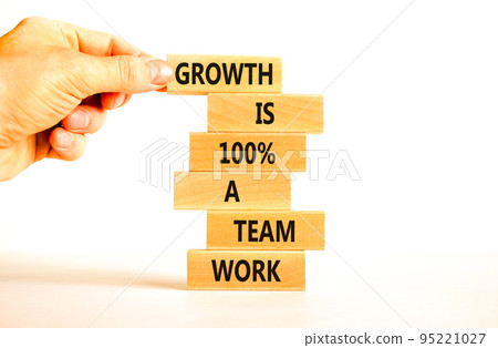 Growth symbol. Concept words Growth is 100 percent a team work on wooden blocks on a beautiful white table white background. Businessman hand. Business motivational and growth is a team work concept. Growth symbol. Concept words Growth is 100 percent a team work on wooden blocks on a beautiful white table white background. Businessman hand. Business motivational and growth is a team work concept. 95221027