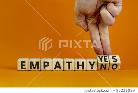 Empathy yes or no symbol. Psychologist turns wooden cubes and changes words empathy no to empathy yes on a beautiful orange background. Psychological and empathy yes or no concept, copy space. 95221059