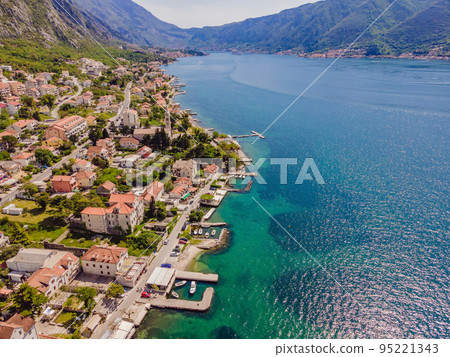 Montenegro. Boka Kotor Gulf. View on the picturesque coastal town of Dobrota, the Institute of Marine Biology and the Church of St. Ilijah Montenegro. Boka Kotor Gulf. View on the picturesque coastal town of Dobrota, the Institute of Marine Biology and the Church of St. Ilijah 95221343