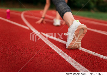 Runner feet in the stadium track 95221639