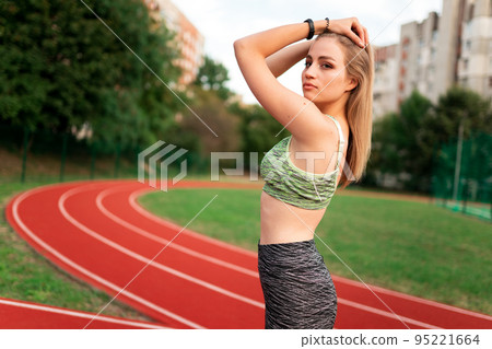 Sports girl on a stadium track Sports girl on a stadium track 95221664