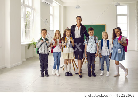 Portrait of female teacher and elementary school students on first day of school. 95222665