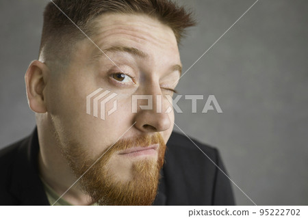 Closeup of funny curious man looking at you with expression of doubt and suspicion 95222702
