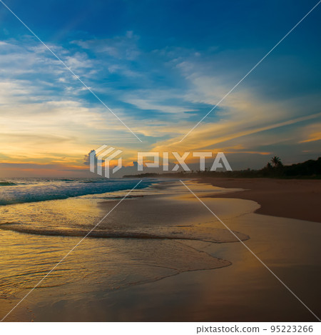 sunset over the beach by the tropical sea. sunset over the beach by the tropical sea. 95223266