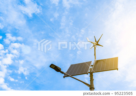 Alternative energy concept. Wind turbine with solar energy power panel, renewable photovoltaic technology. Renewable energy sources concept. 95223505