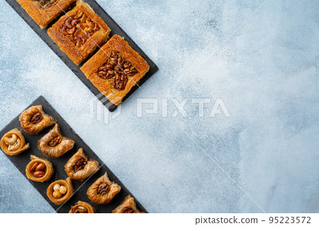 Top view of Turkish desserts on light blue background 95223572