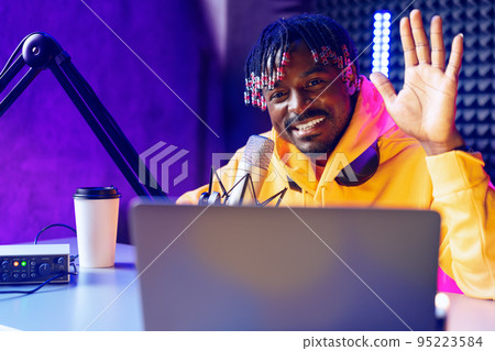 Happy young african man audio blogger broadcasting at studio Happy young african man audio blogger broadcasting at studio 95223584