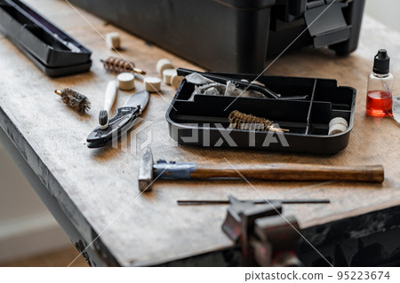 Set of tools for cleaning and repairing weapons in workshop Set of tools for cleaning and repairing weapons in workshop 95223674