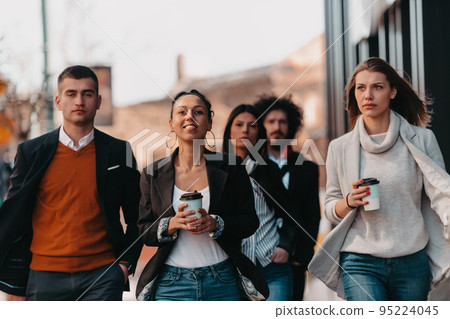 Elegant businesspeople walking in a modern city.. Elegant businesspeople walking in a modern city.. 95224045