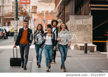 Elegant businesspeople walking in a modern city.. 95224047