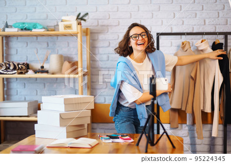 Female warehouse worker, seller, dropshipping small business owner recording new content for vlog. Female warehouse worker, seller, dropshipping small business owner recording new content for vlog. 95224345