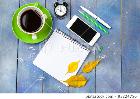 Modern workplace with cup of coffee on wooden table Modern workplace with cup of coffee on wooden table 95224750