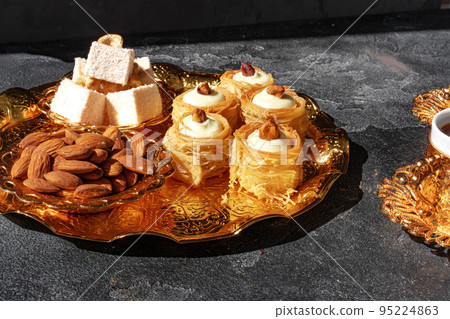 Turkish dessert baklava with a cup of coffee on black background 95224863