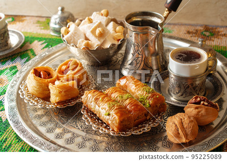 Traditional arabic dessert baklava with a cup of turkish coffee Traditional arabic dessert baklava with a cup of turkish coffee 95225089