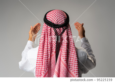 Back view of young Arab man standing on gray background 95225159