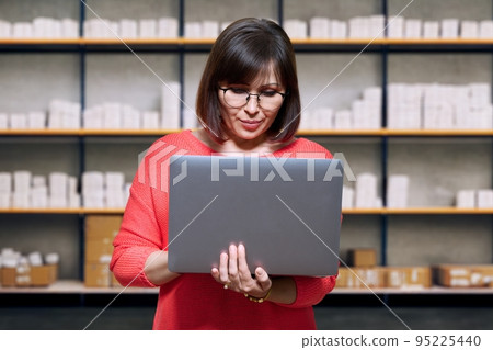 Warehouse woman picking online orders for shipping Warehouse woman picking online orders for shipping 95225440