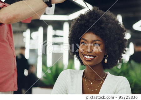 Young african woman customer getting a hairstyle at a beauty salon. 95225836