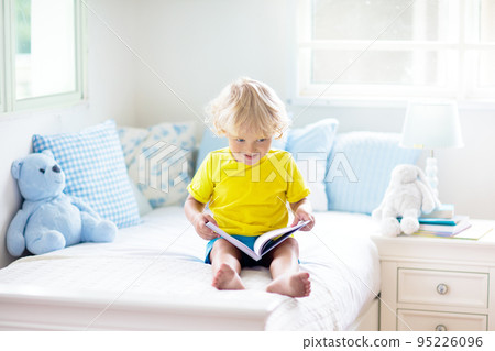 Child playing in bed. Kids room. Baby boy at home. Child playing in bed. Kids room. Baby boy at home. 95226096
