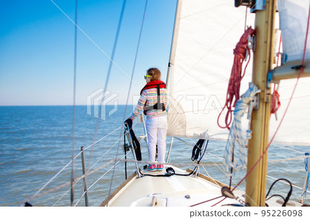 Kids sail on yacht in sea. Child sailing on boat. Kids sail on yacht in sea. Child sailing on boat. 95226098
