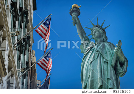 View Statue of Liberty near US building in flying flag United States America View Statue of Liberty near US building in flying flag United States America 95226105