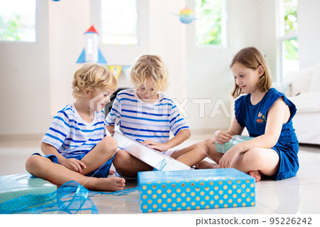 Space theme kids birthday party. Boy with present. Space theme kids birthday party. Boy with present. 95226242