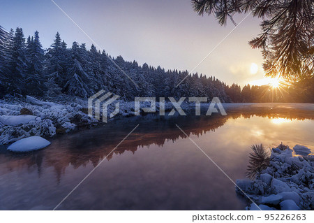 Beautiful Winter Landscape with Pine Forest and Sunset Reflections in the Lake Beautiful Winter Landscape with Pine Forest and Sunset Reflections in the Lake 95226263