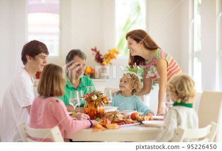 Family with kids at Thanksgiving dinner. Turkey. 95226450