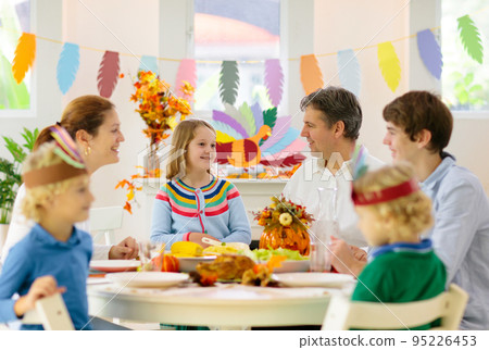 Family with kids at Thanksgiving dinner. Turkey. Family with kids at Thanksgiving dinner. Turkey. 95226453