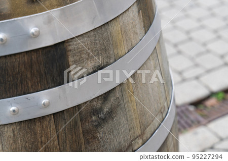 oak barrel with iron hoops close up on blurred background of city square oak barrel with iron hoops close up on blurred background of city square 95227294