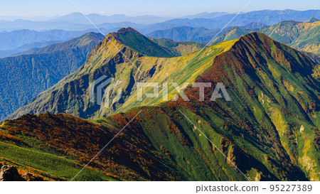 View from near the summit of Mt. Tanigawa, with the mountains of the Tanigawa mountain range colored with autumn leaves and a clear sky View from near the summit of Mt. Tanigawa, with the mountains of the Tanigawa mountain range colored with autumn leaves and a clear sky 95227389