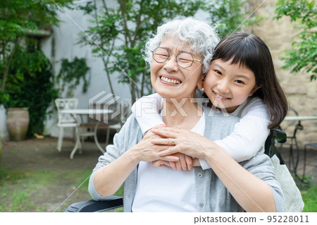 Senior woman in wheelchair and granddaughter girl Senior woman in wheelchair and granddaughter girl 95228011